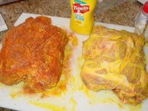 Pork butts slathered with mustard and rub