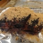 Applying brown sugar to pork butt