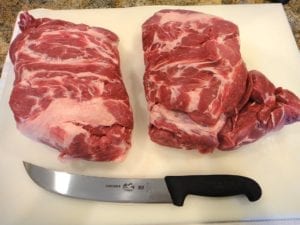 Two untrimmed pork butts removed from packaging