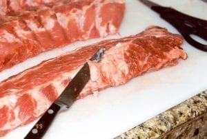 Trimming fat from the meat side
