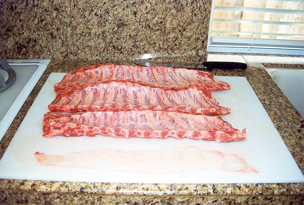 Trimmed slabs of ribs with membrane in foreground