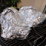 Foiled pork butts go back into the WSM for at least 2 more hours.