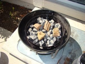 Smoke wood chunks on top of hot coals