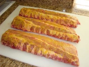 Three slabs brushed with yellow mustard