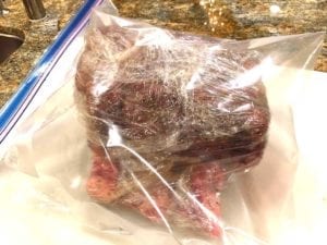 Roast wrapped in plastic wrap and placed in Ziploc bag