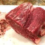 Trimmed standing rib roast with removed fat on the side