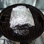 Foiled short ribs go back into the cooker