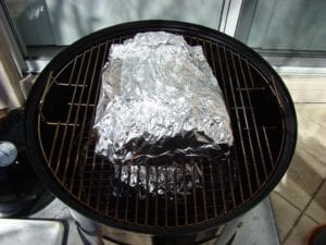 Foiled short ribs go back into the cooker