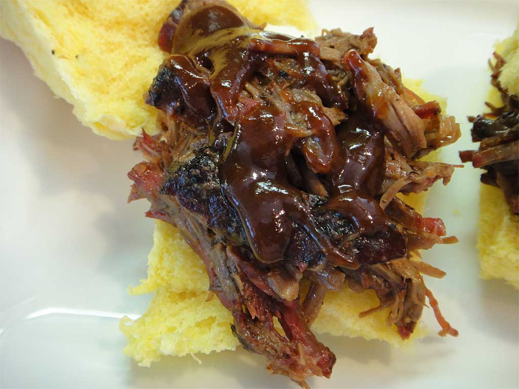 Close-up of shredded barbecued beef slider with sauce
