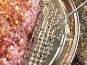 Poking holes in foil pan for grease drainage