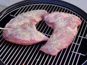 Uncooked, seasoned tri-tip roasts go into WSM