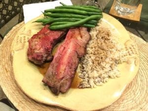 Beef rib bones served with rice and green beans