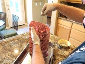 Applying seasoning to end of roast