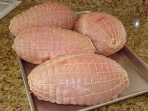 Netted turkey breasts before smoking