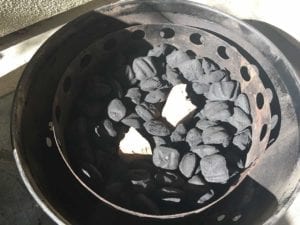 Smoke wood chunks tucked into 1/3 full charcoal chamber of unlit briquets