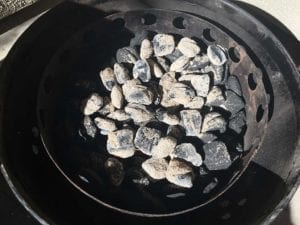Lit charcoal spread over smoke wood & unlit briquets