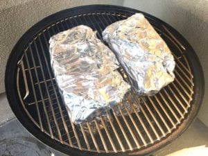Foiled turkey breasts placed former skin-side down in the WSM