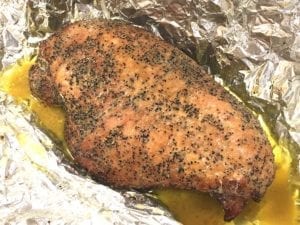 Boneless, skinless turkey breast resting in melted butter