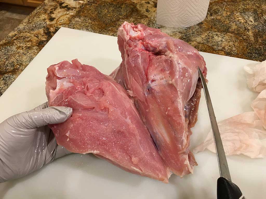 Pulling breast meat away from rib cage