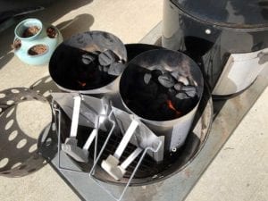 Lighting two Weber chimney starter of charcoal