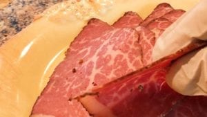 Profile view of 1mm thick pastrami slices