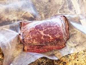 Four ounce portion of sliced pastrami frozen in vacuum bag