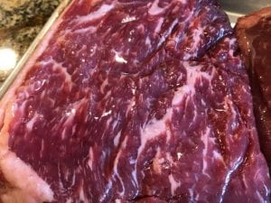 Close-up of corned beef round showing intramuscular fat marbling