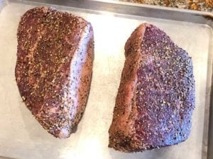 Two corned beef rounds with pastrami rub generously applied