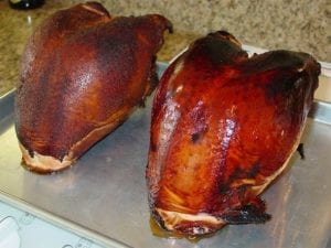 Two bone-in turkey breasts after barbecuing