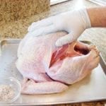 Applying rub to turkey skin