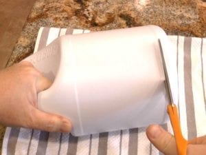Remove the bottom of the bleach bottle just above the reinforced rim