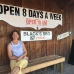 My wife Julie sitting in front of Black's Barbecue