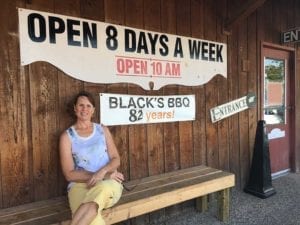 My wife Julie sitting in front of Black's Barbecue