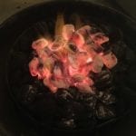 Hot coals dumped on top of unlit charcoal