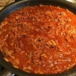 Brisket and ground beef chili simmering in skillet