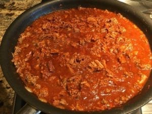 Brisket and ground beef chili simmering in skillet