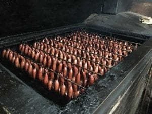 Close-up view of sausage rings in pit