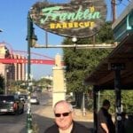 Chris Allingham posing with the Franklin Barbecue sign