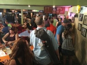 Customers lined up as they approach the meat cutter