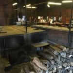 Looking across pits toward the meat cutting area and front counter