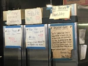 Lots of signs on white butcher paper