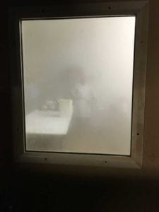 Steamy view into sausage prep room