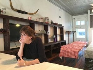 Nina Sells leans on counter and tells us about new overflow dining room