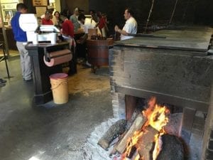 Pit room with wood fire burning on floor next to pit