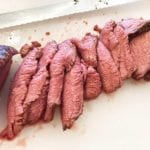 Thin slices of tri-tip carved by hand