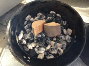 Apple wood chunks placed on hot charcoal
