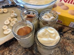 Constructing banana pudding in Mason jars