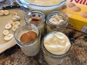 Constructing banana pudding in Mason jars