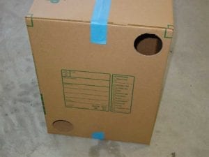 Two holes cut into side of box