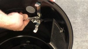 Removing bottom nut from grills strap